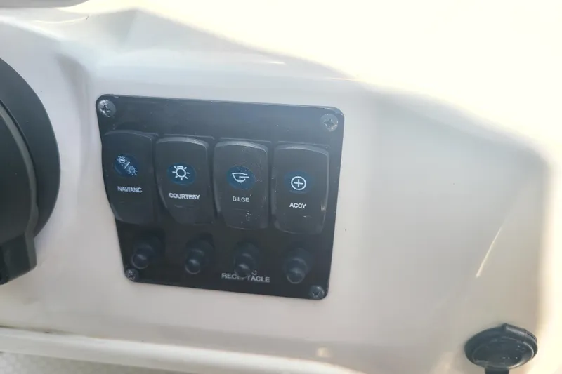 Slide: The Image of Control panel of 2023 Stingray 182 SC boat with labeled switches. - 7
