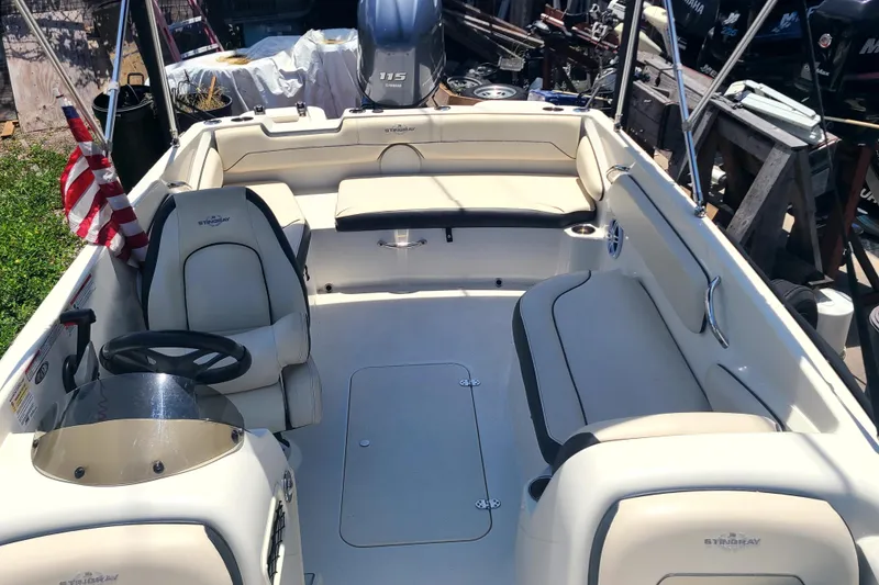 Slide: The Image of 2023 Stingray 182 SC boat interior with seating and steering wheel. - 9