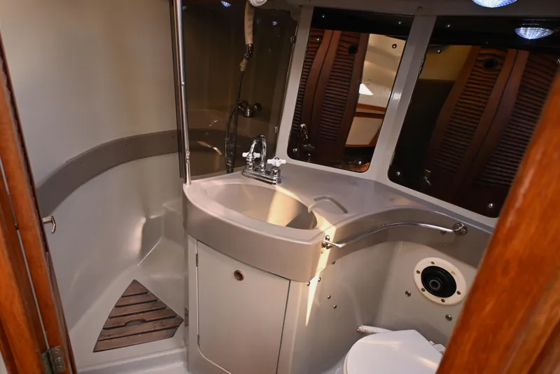 Slide: The Image of 1989 C&C 37/40+ yacht bathroom with sink, mirror, and wooden accents. - 10