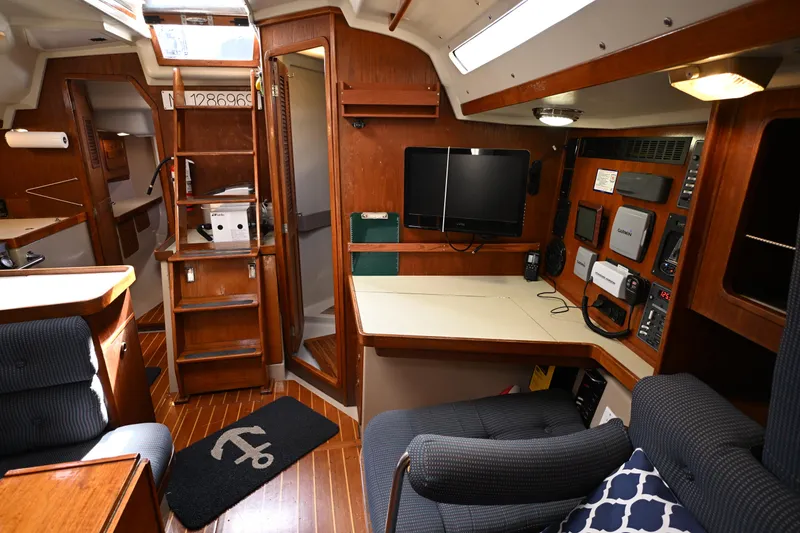Slide: The Image of Interior of 1989 C&C 37/40+ sailboat with navigation station and wooden cabinetry. - 11