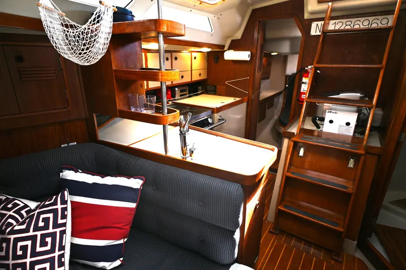 Slide: The Image of Interior of 1989 C&C 37/40+ sailboat with cozy seating and wooden cabinetry. - 12