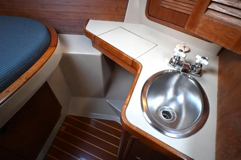 Slide: The Image of 1989 C&C 37/40+ yacht interior with sink and wooden cabinetry. - 14