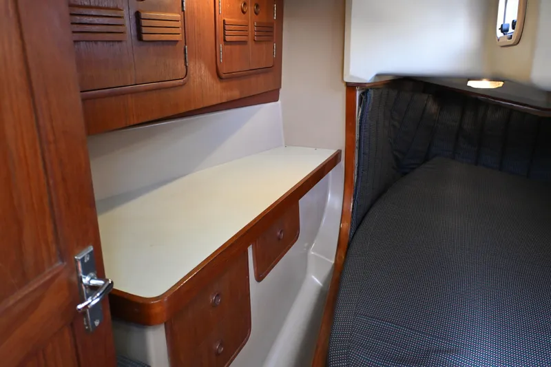 Slide: The Image of Interior cabin of 1989 C&C 37/40+ sailboat with wooden cabinetry and cozy sleeping area. - 15