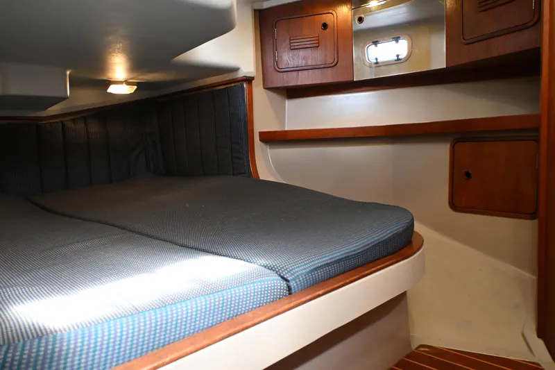 Slide: The Image of Cozy cabin interior of 1989 C&C 37/40+ sailboat with wooden accents and bedding. - 16