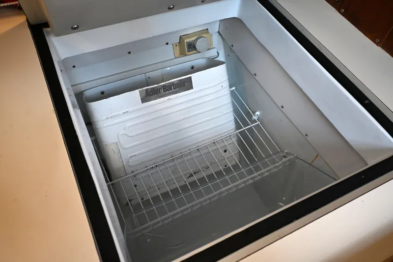 Slide: The Image of Adler Barbour refrigerator inside 1989 C&C 37/40+ sailboat, featuring wire shelving. - 17