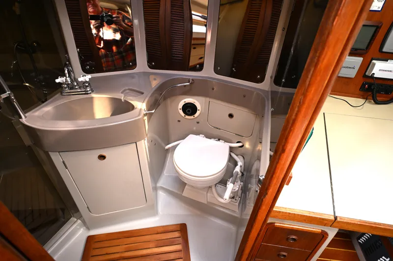 Slide: The Image of Compact bathroom in 1989 C&C 37/40+ sailboat with sink, toilet, and wooden accents. - 18