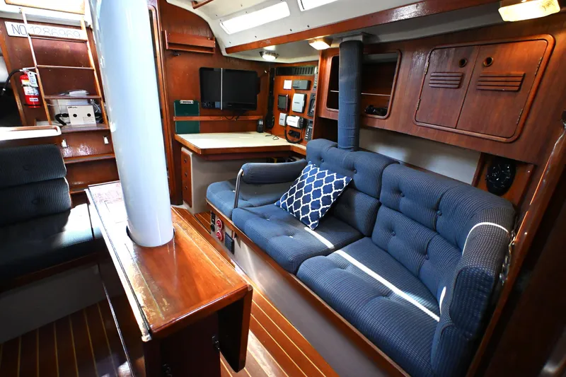 Slide: The Image of Interior of 1989 C&C 37/40+ sailboat with blue seating and wooden accents. - 2