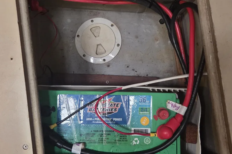 Slide: The Image of Battery compartment of a 1989 C&C 37/40+ sailboat with Interstate battery and wiring. - 24