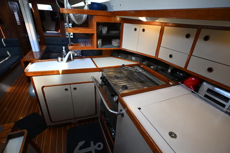Slide: The Image of Interior of 1989 C&C 37/40+ yacht featuring a compact kitchen with wooden cabinetry. - 6