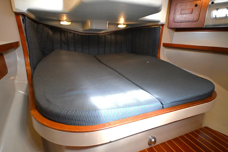 Slide: The Image of Cozy cabin interior of 1989 C&C 37/40+ sailboat with cushioned berth and wooden accents. - 8