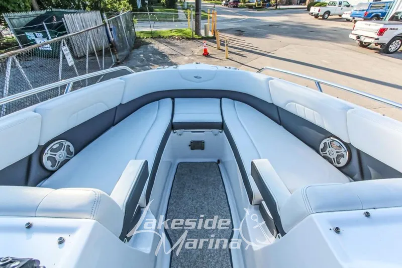 Slide: The Image of 2013 Chaparral 257 SSX boat interior with white seating and speakers at Lakeside Marina. - 10