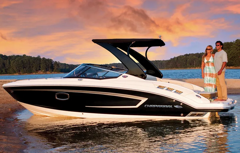 Slide: The Image of Manufacturer Provided Image: 2013 Chaparral 257 SSX boat on water at sunset with two people. - 13