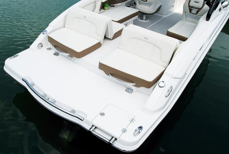Slide: The Image of Manufacturer Provided Image: 2013 Chaparral 257 SSX boat with white and tan seating on water. - 20