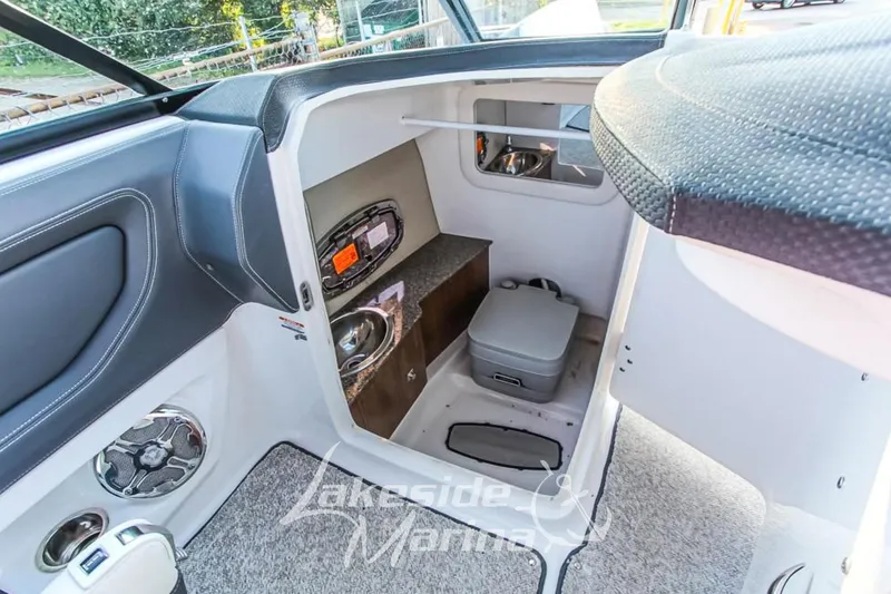 Slide: The Image of Interior of 2013 Chaparral 257 SSX boat featuring compact restroom amenities. - 9