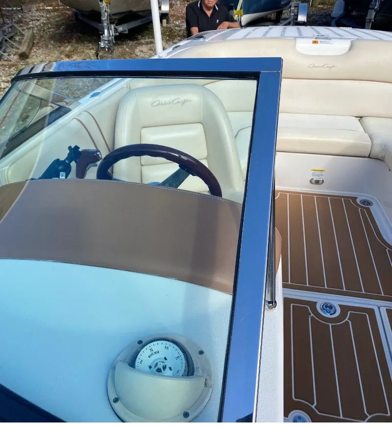 Slide: The Image of Interior of a 2007 Chris-Craft Launch 22 boat with steering wheel and seats. - 5