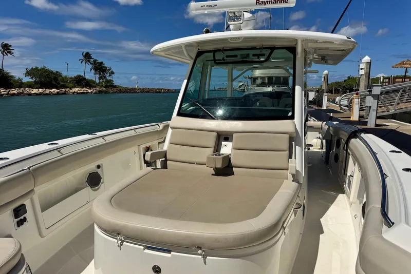 Slide: The Image of 2019 Boston Whaler 380 Outrage boat docked, featuring spacious seating and modern design. - 12