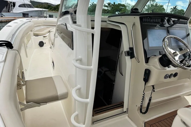 Slide: The Image of 2019 Boston Whaler 380 Outrage boat interior with helm, seating, and navigation screens. - 13