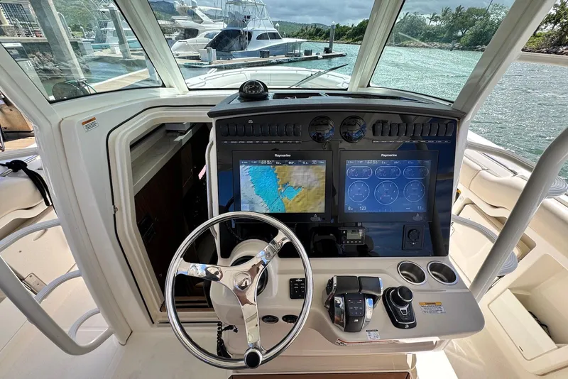Slide: The Image of 2019 Boston Whaler 380 Outrage helm with advanced navigation displays and controls. - 14