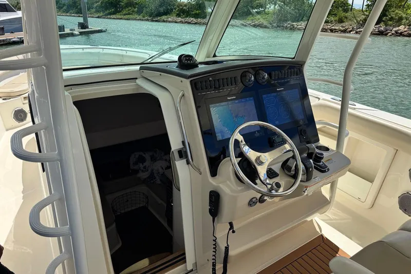 Slide: The Image of 2019 Boston Whaler 380 Outrage helm with advanced navigation system and steering wheel. - 17