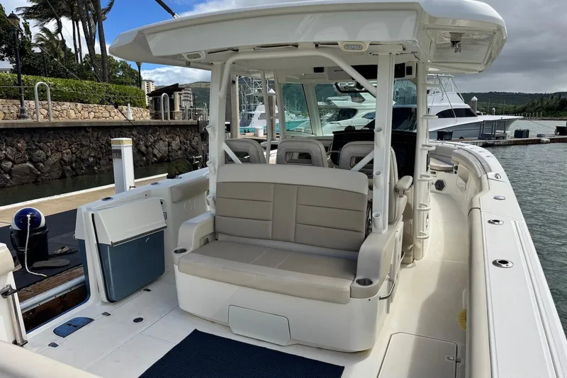 Slide: The Image of 2019 Boston Whaler 380 Outrage boat docked, featuring spacious seating and sleek design. - 20