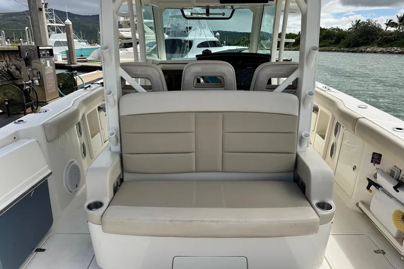 Slide: The Image of 2019 Boston Whaler 380 Outrage boat interior with beige seating and helm station. - 21