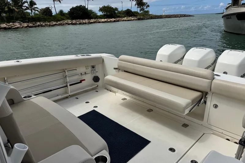 Slide: The Image of 2019 Boston Whaler 380 Outrage boat interior with seating and multiple outboard engines. - 22