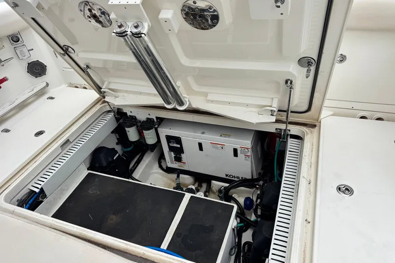 Slide: The Image of Open engine compartment of 2019 Boston Whaler 380 Outrage, showcasing Kohler generator and components. - 24