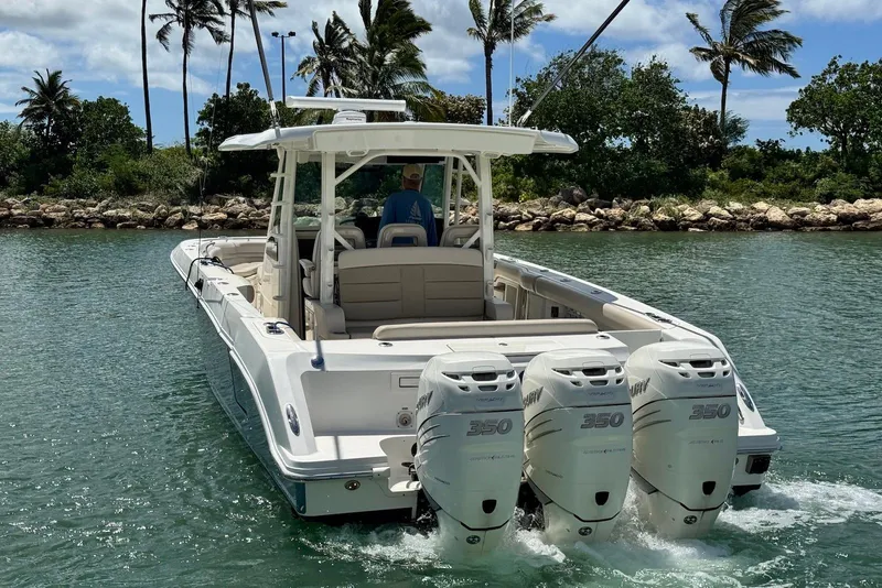 Slide: The Image of 2019 Boston Whaler 380 Outrage boat with triple engines cruising in tropical waters. - 7