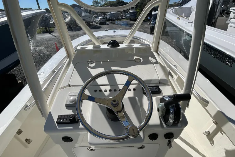 Slide: The Image of 2004 Gloucester G-20 boat helm with steering wheel and controls, docked in a marina. - 10