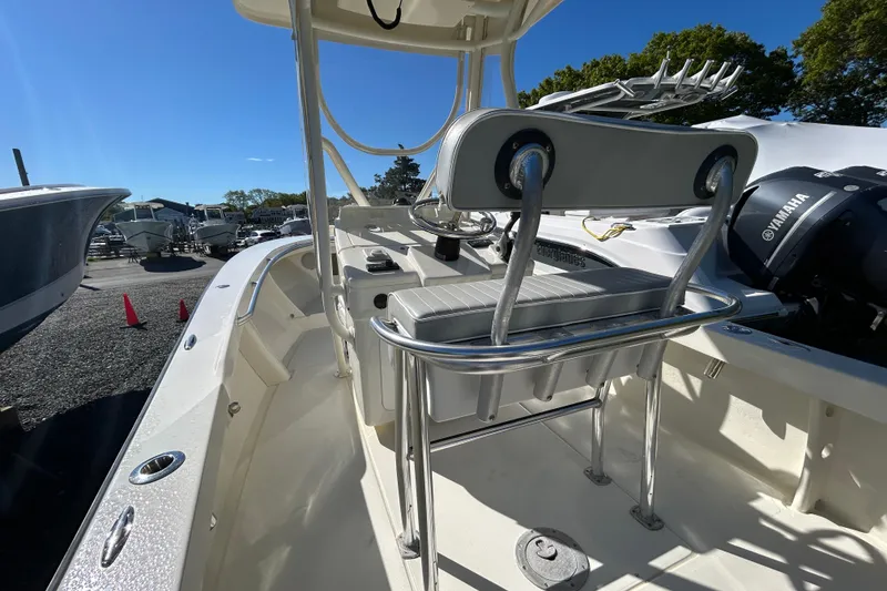 Slide: The Image of 2004 Gloucester G-20 boat interior with seating and Yamaha engine, docked under clear blue sky. - 11