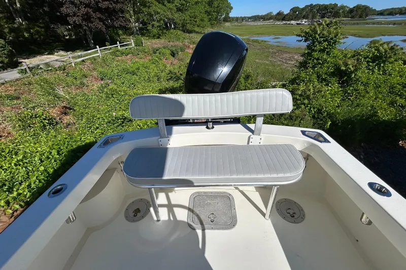 Slide: The Image of 2004 Gloucester G-20 boat interior with seating and lush green surroundings. - 13