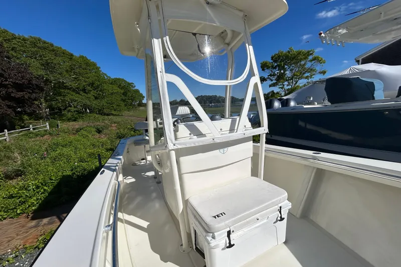 Slide: The Image of 2004 Gloucester G-20 boat with Yeti cooler, docked near lush greenery. - 16