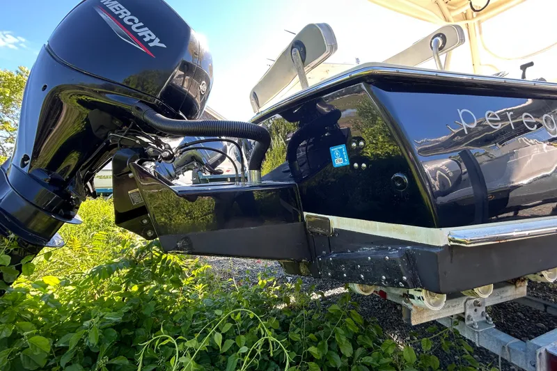 Slide: The Image of Boat with Mercury outboard motor, Gloucester G-20 model, 2004, on trailer surrounded by greenery. - 17