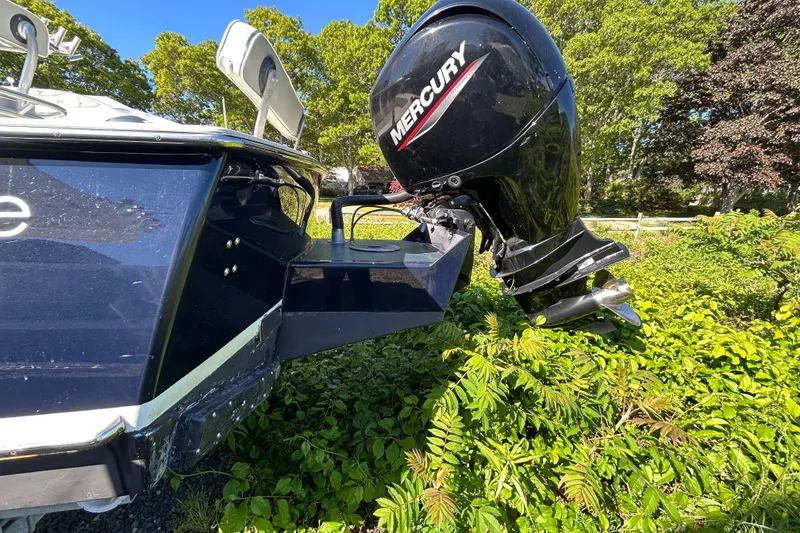 Slide: The Image of Boat with Mercury outboard motor, Gloucester G-20 model, 2004, surrounded by greenery. - 18