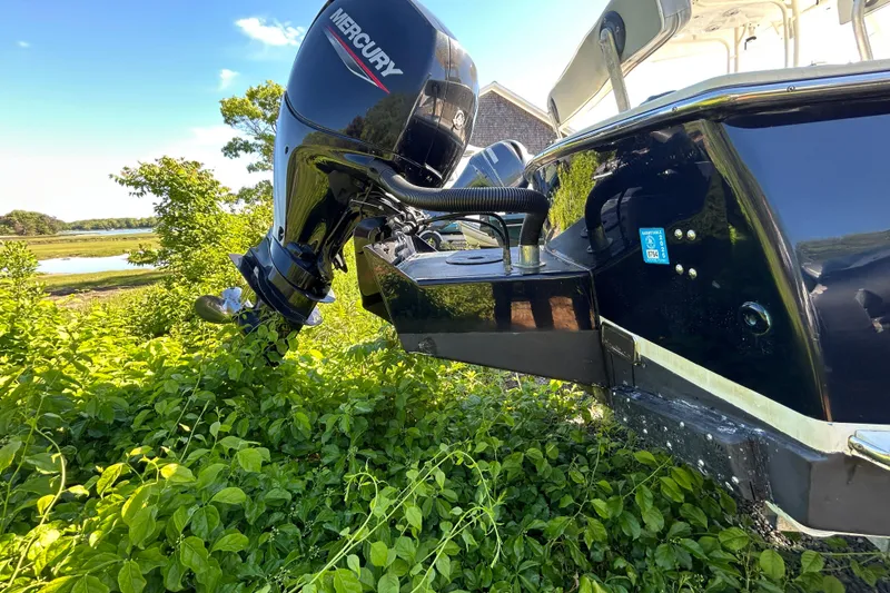 Slide: The Image of Outboard motor on a 2004 Gloucester G-20 boat, surrounded by lush greenery. - 19