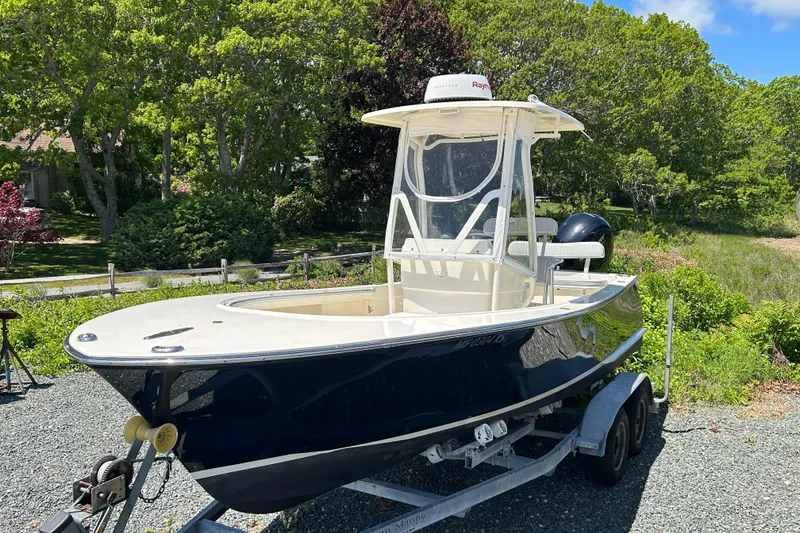 Slide: The Image of 2004 Gloucester G-20 boat on trailer, surrounded by lush greenery. - 3