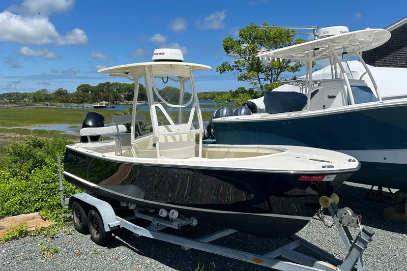 Slide: The Image of 2004 Gloucester G-20 boat on trailer, parked outdoors under clear blue sky. - 6