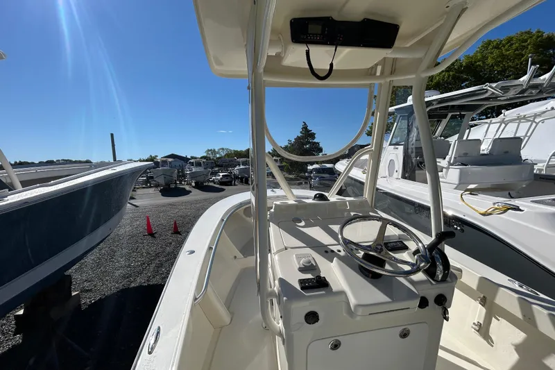 Slide: The Image of 2004 Gloucester G-20 boat interior with steering wheel, docked under clear blue sky. - 8