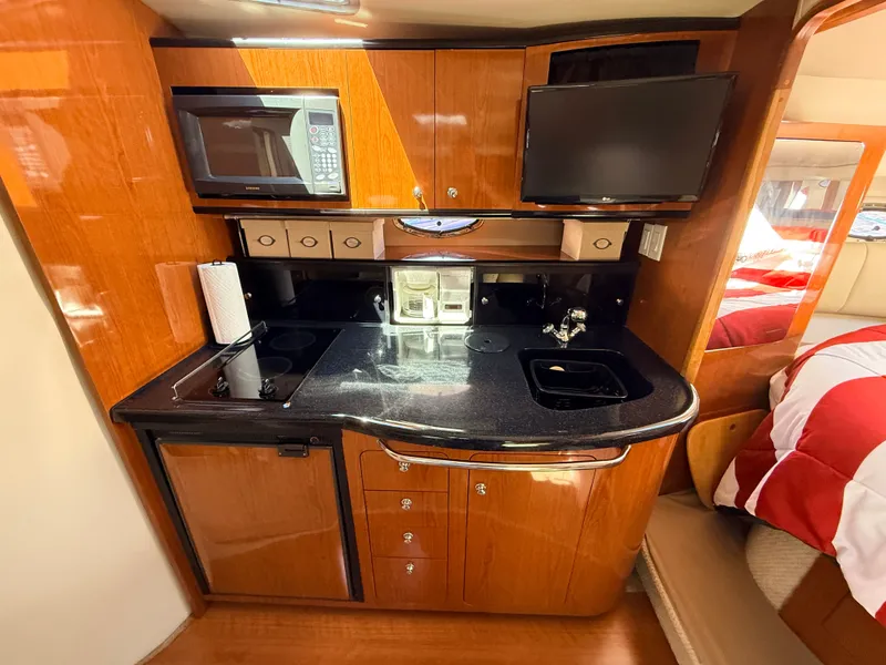 Slide: The Image of Interior of 2001 Chaparral 350 Signature with kitchen and sleeping area. - 11