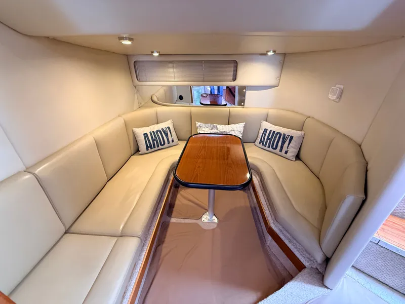 Slide: The Image of Interior of 2001 Chaparral 350 Signature with beige sofa and wooden table. - 14