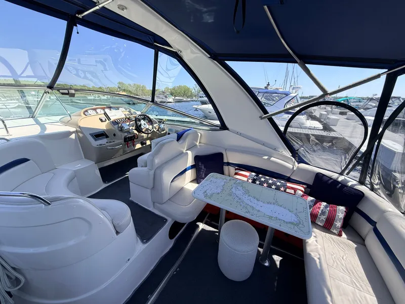Slide: The Image of Interior of a 2001 Chaparral 350 Signature yacht with maps on the table. - 5