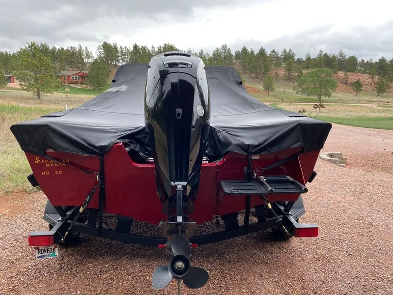 Slide: The Image of 2021 Tracker Pro Guide boat with cover on trailer. - 3
