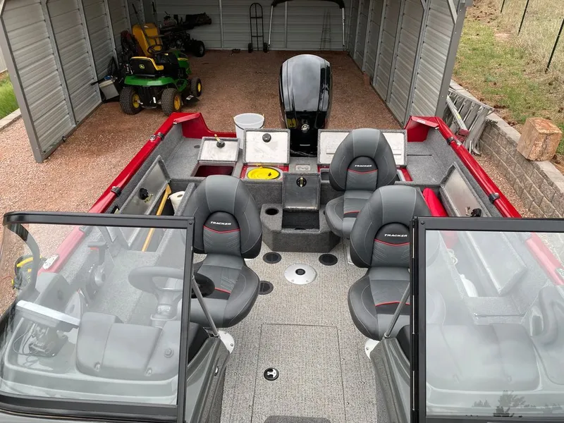 Slide: The Image of 2021 Tracker Pro Guide boat in garage with lawnmower. - 4