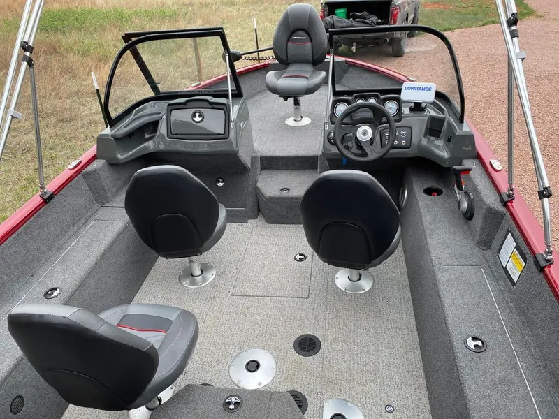 Slide: The Image of Interior of a 2021 Tracker Pro Guide boat with seats and console. - 5