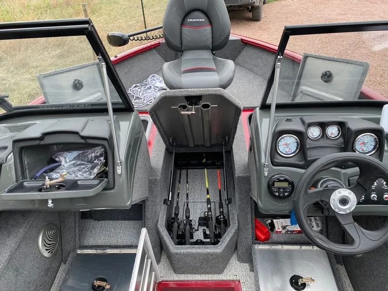 Slide: The Image of Interior view of a 2021 Tracker Pro Guide boat with controls and storage. - 6