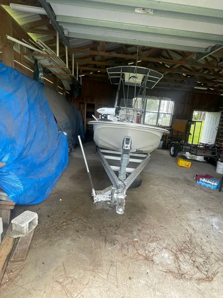 Slide: The Image of 2015 Carolina Skiff 198 DLV boat stored in a garage. - 2