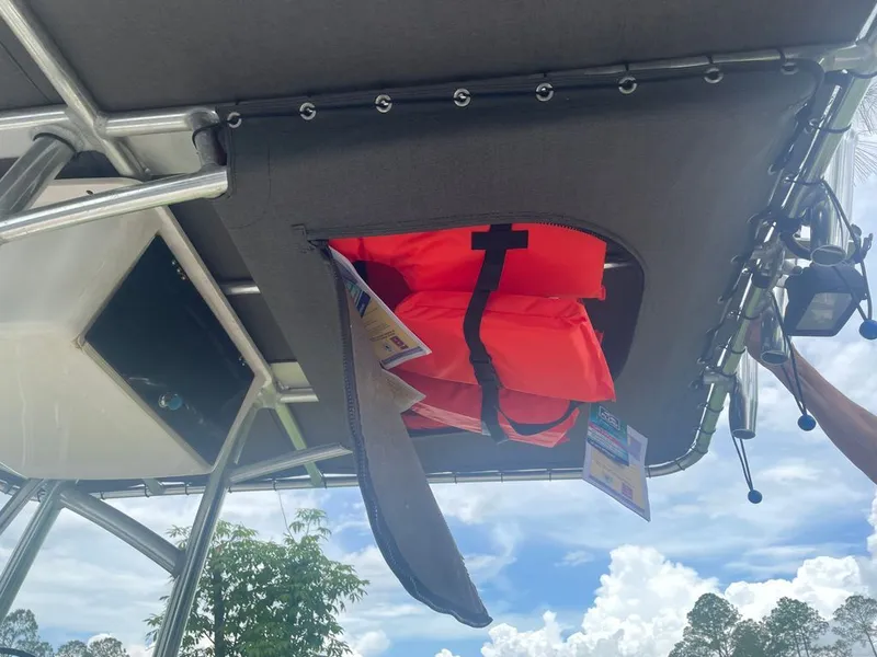 Slide: The Image of 2015 Carolina Skiff 198 DLV with life jacket stored under canopy. - 6