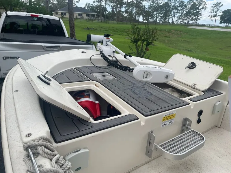 Slide: The Image of 2015 Carolina Skiff 198 DLV with open storage compartments and Minn Kota motor. - 7