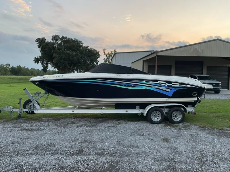 The Image of 2006 Sea Ray 220 Select boat on trailer at sunset. - 0
