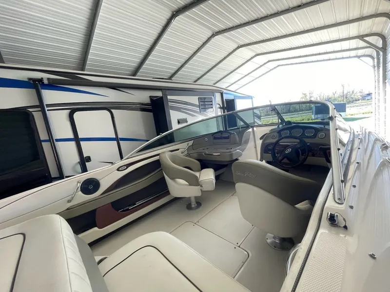 Slide: The Image of Interior of a 2006 Sea Ray 220 Select boat in a garage. - 4